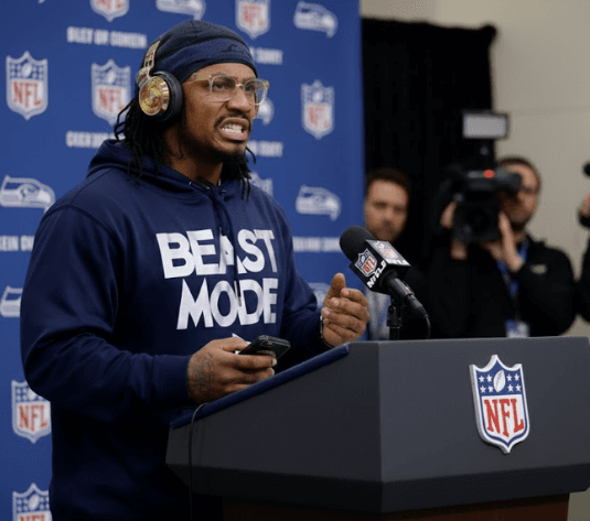 Beast Mode Marshawn Lynch Speaks Out To Defend Seahawks After Hall Of Famer Troy Aikman's "Deliberate Dirty Play" Accusation Live On ESPN — The Reason Behind The Allegation Has The Seattle Community Outraged Following 27-10 Win Over Panthers.